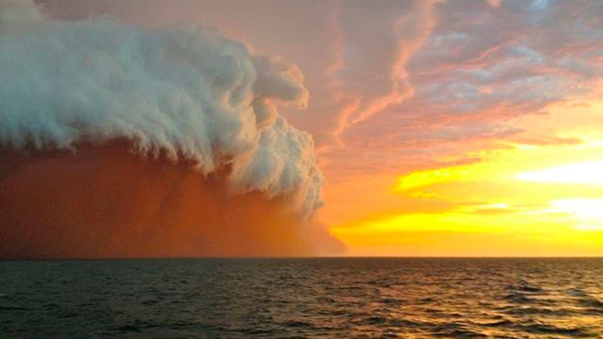 A dust cloud travels over water off the Western Australian coast on January 9, 2013.