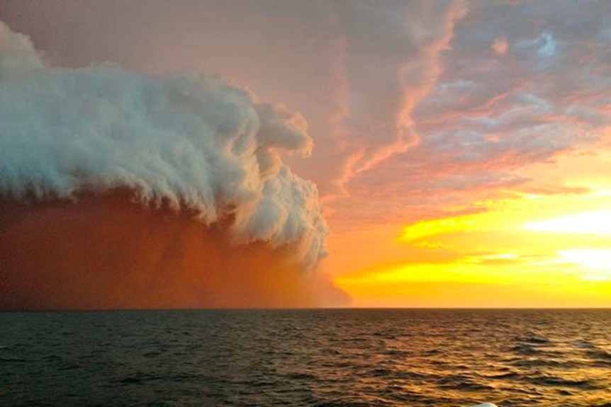 A dust cloud travels over water off the Western Australian coast on January 9, 2013.