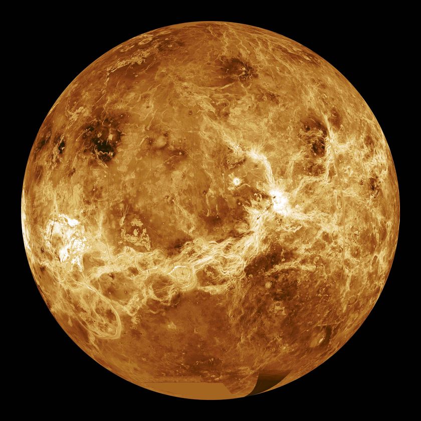 A planet in space that appears a bright golden orange colour.