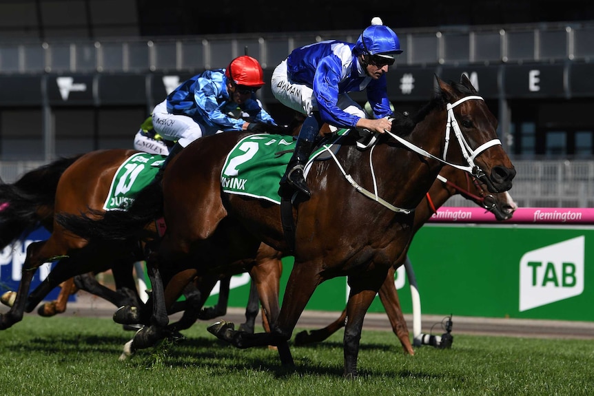 Jockey Hugh Bowman (R) rides Winx to victory in the Turnbull Stakes at Flemington on October 6, 2018.