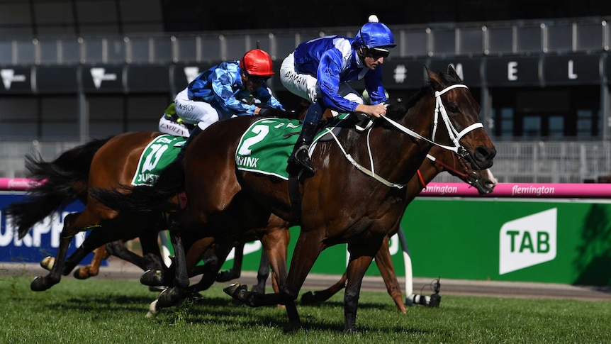 Jockey Hugh Bowman (R) rides Winx to victory in the Turnbull Stakes at Flemington on October 6, 2018.