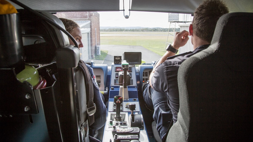 Aviation Firefighters, Amelia Dever Kavanagh and Simon Owen prepare to operate the ULFV on the tarmac.