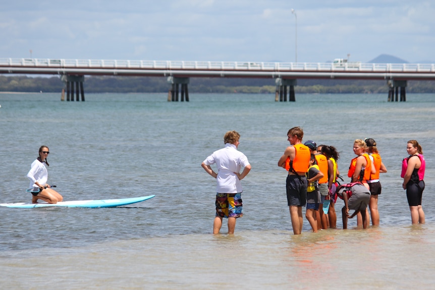 The students were taught how to stand up paddle board in the calm water of Bribie Island.