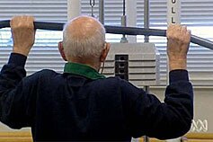 An older man exercises in a gym