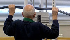 An older man exercises in a gym