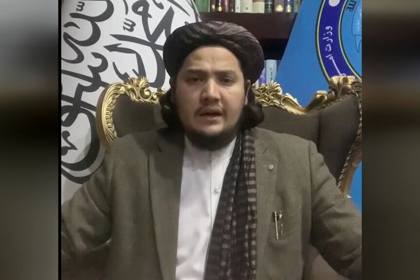A man in traditional Afghani garb speaks during a statement.