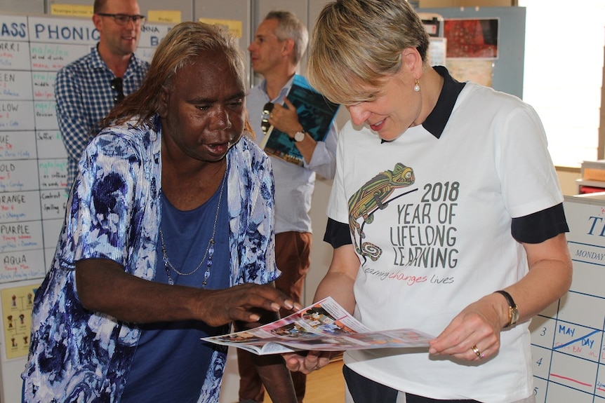 Ormay Nantala Gallagher shows Tanya Plibersek a Warlpiri book at the higher learning centre