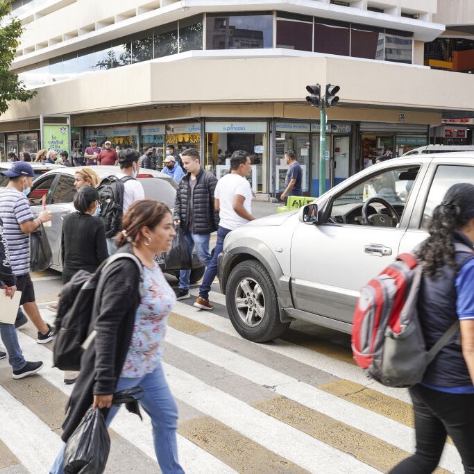 Pedestrians and cars battle for road space in Guatemala City