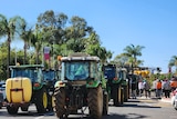 Dozens of tractors, harvesters and trucks lined the street outside the Renmark Hotel on a sunny day.