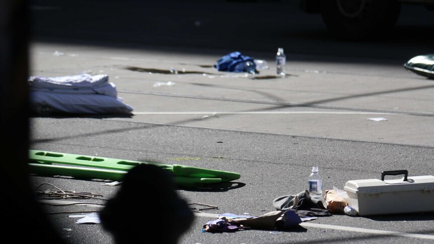 Debris and an aid kit lie on the road