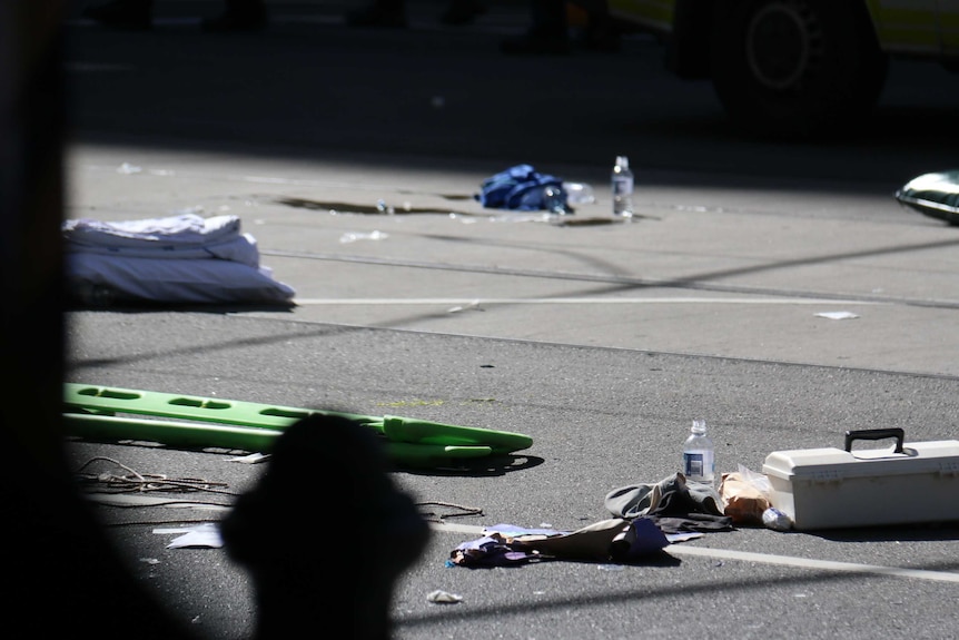 Debris and an aid kit lie on the road