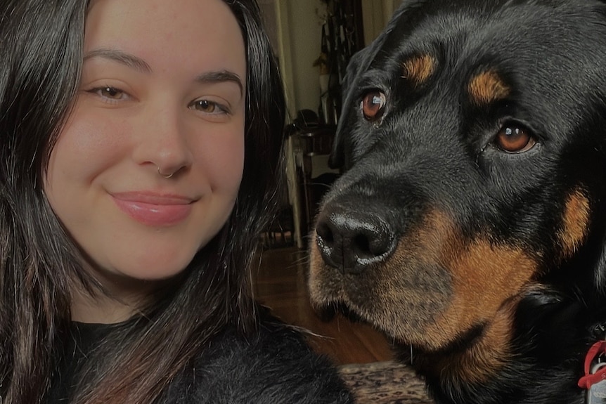 A selfie of a girl with a rottweiler