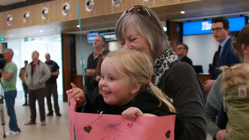 Sadie Myors waiting with family for her aunt Emily Myors on the day Tasmania's borders reopen.