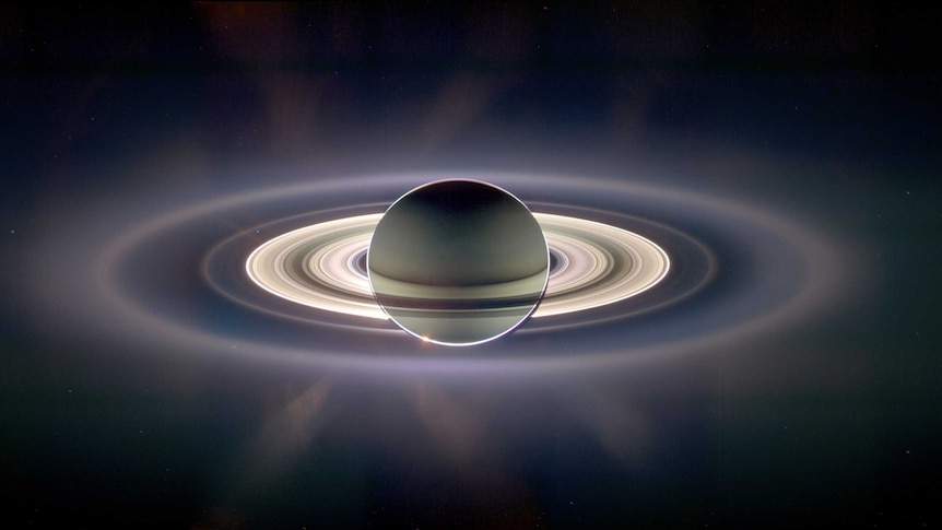 The planet Saturn as seen from the Cassini spacecraft. Its rings are illuminated against dark space