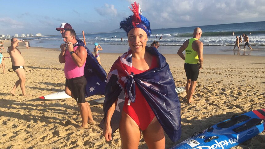 Mooloolaba lifesaver Sammy Hemsley wears an Aussie flag with her bathing suit and face paint