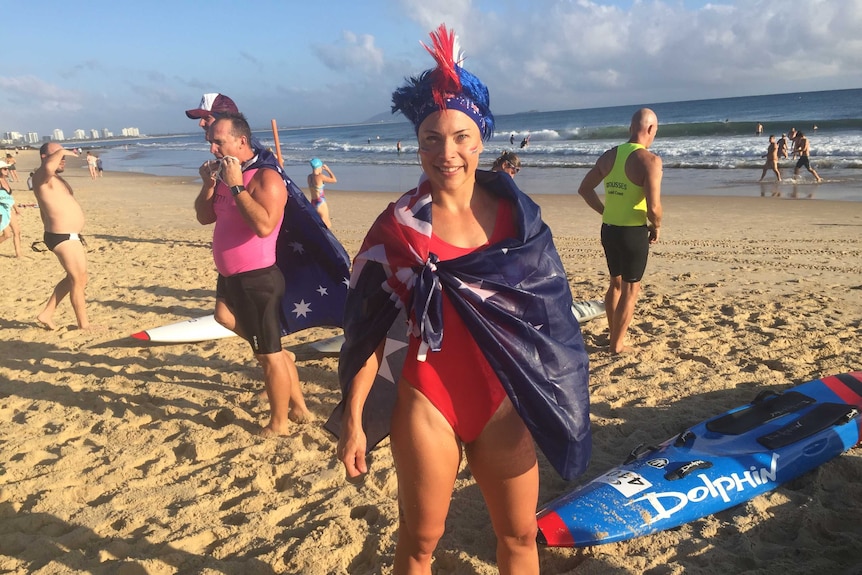 Mooloolaba lifesaver Sammy Hemsley wears an Aussie flag with her bathing suit and face paint