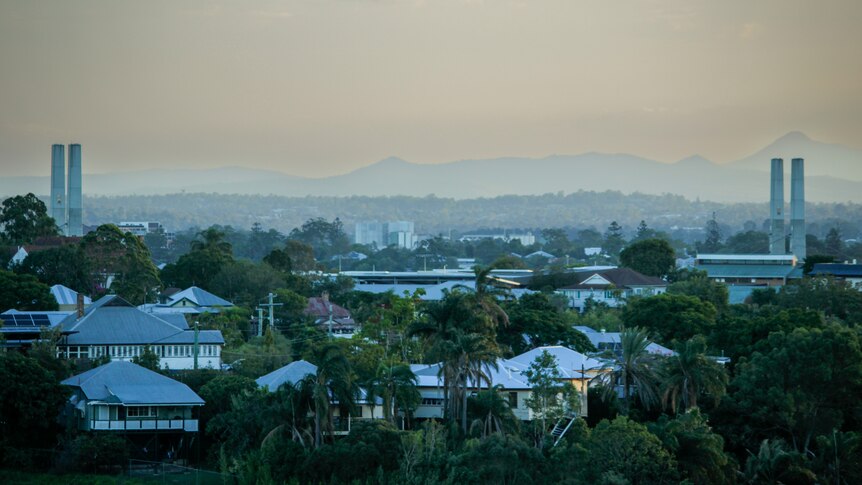 A hazy view of mountains over suburbia. 