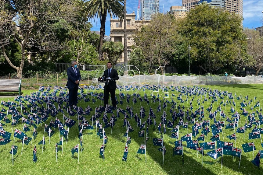 Michael O'Brien and Nationals leader Peter Walsh give a press conference in a park surrounded by 791 miniature Australian flags.