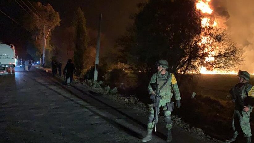 Law enforcement stand guard at the scene of a pipeline explosion in Mexico.