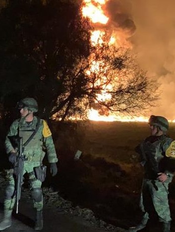 Law enforcement stand guard at the scene of a pipeline explosion in Mexico.