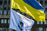 A Ukrainian flag flies above the flag for the country's national Olympic committee.