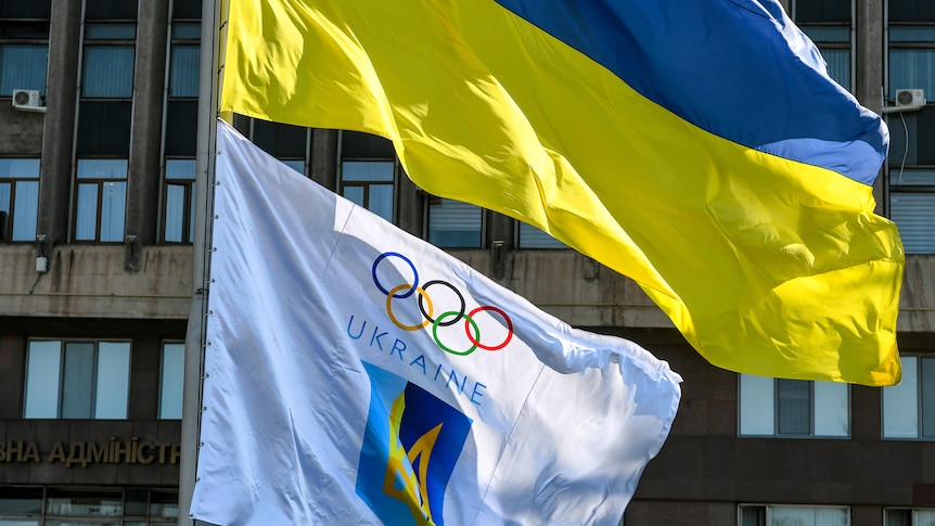 A Ukrainian flag flies above the flag for the country's national Olympic committee.