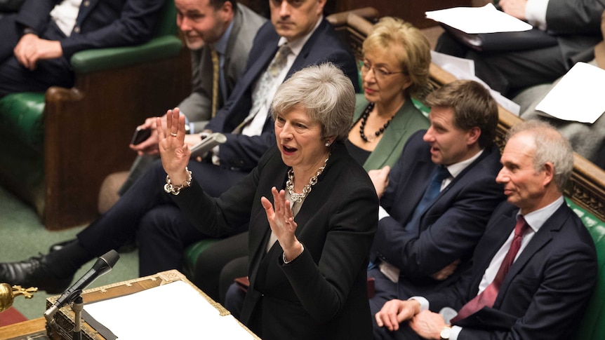 Britain's Prime Minister Theresa May reacts as she addresses the House of Commons.