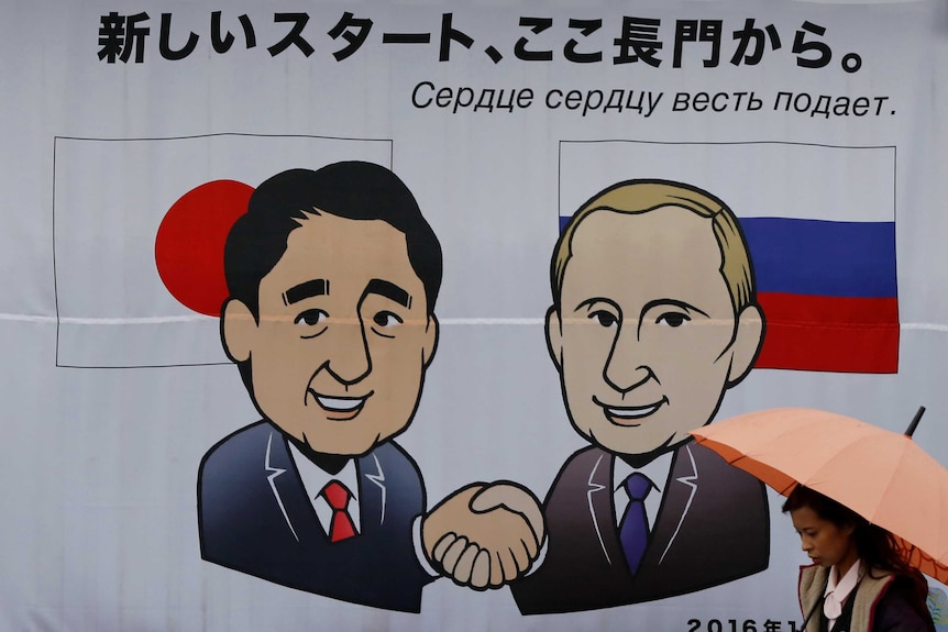 Banner shows Japan's Prime Minister Shinzo Abe and Russian President Vladimir Putin