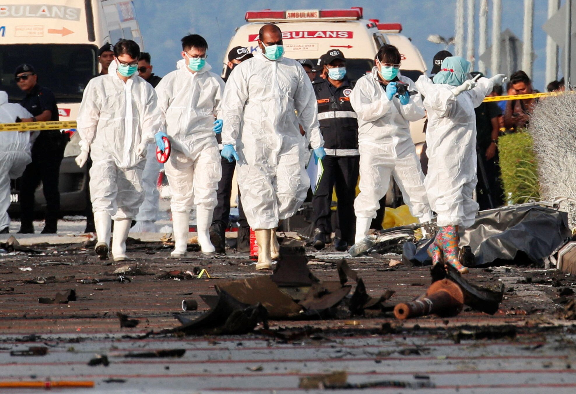 Authorities inspect the scene of a plane crash in Shah Alam, Malaysia /