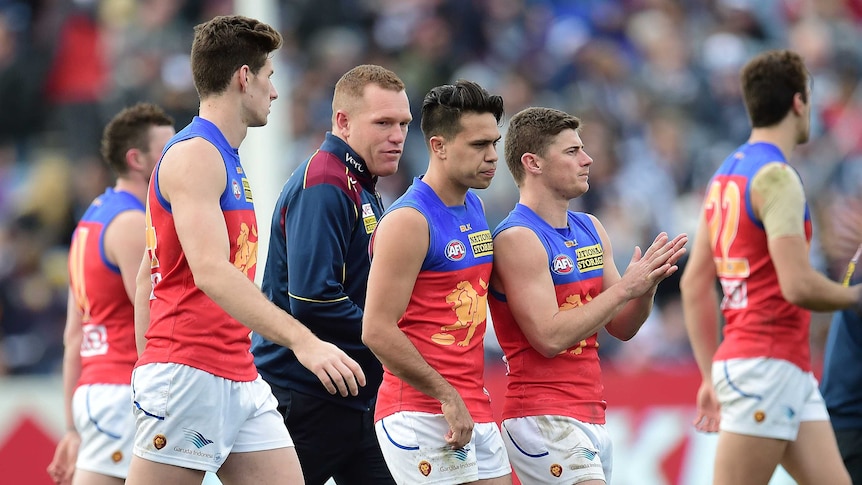 Brisbane coach Justin Leppitsch (3L) with players during match against Geelong at Kardinia Park.