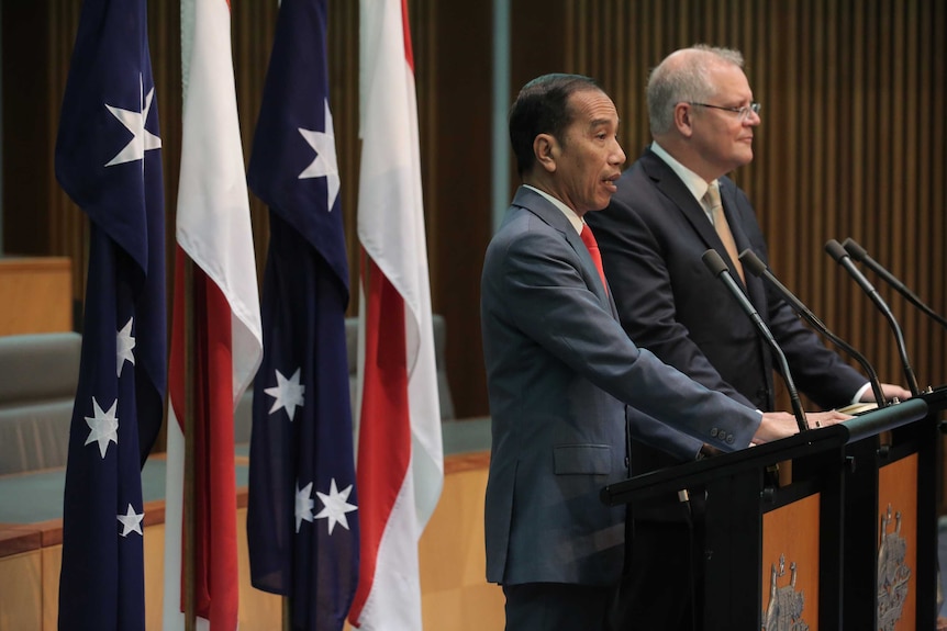 Joko Widodo and Scott Morrison speak in front of Australian and Indonesian flags