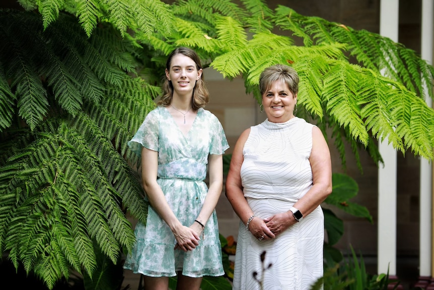 Emma Sellars with All Kinds Of Minds program manager Slavica Crnic in front of tree ferns