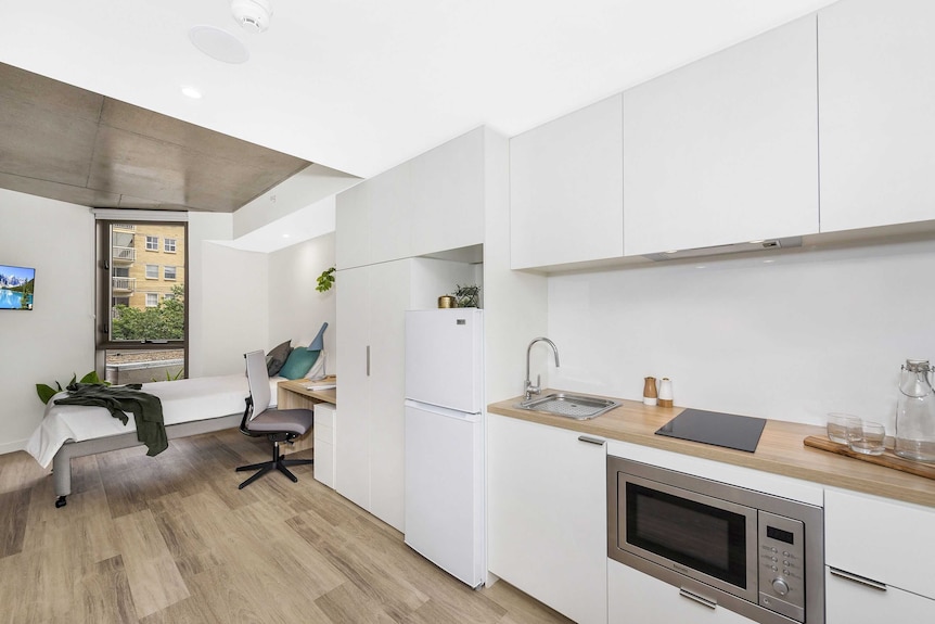 A room at Atria Glen Road showing a bed and self-contained kitchen.