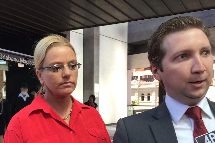 Library assistant Sally Kuether outside a Brisbane court with her lawyer