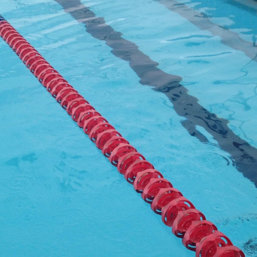 A red lane rope in a swimming pool.