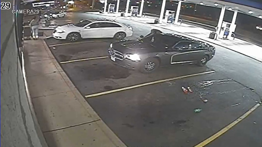 Video surveillance footage of two cars at petrol station