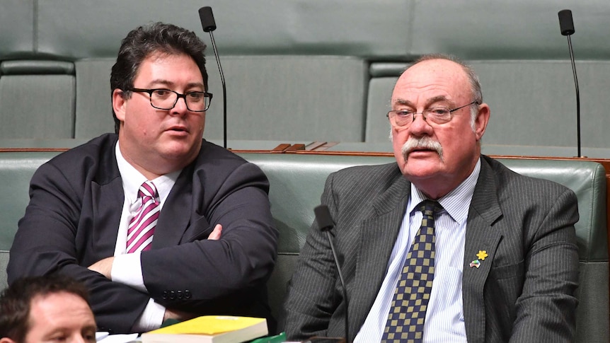 George Christensen crosses his arms as he speaks to Warren Entsch during Question Time