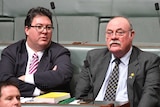 George Christensen crosses his arms as he speaks to Warren Entsch during Question Time