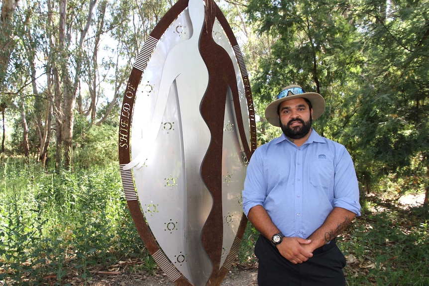 Curtis Reid in front of Shield of Reconciliation