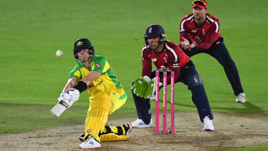 Steve Smith reaches forward on one knee and plays a ramp shot over the head of the England wicketkeeper