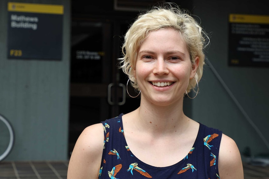 Twenty something lady smiles at camera. She's very pretty- not important but reminder: not all scientists are old men