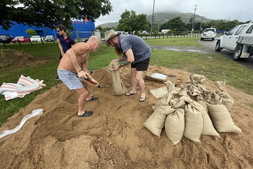 Locals put sand in sandbags.