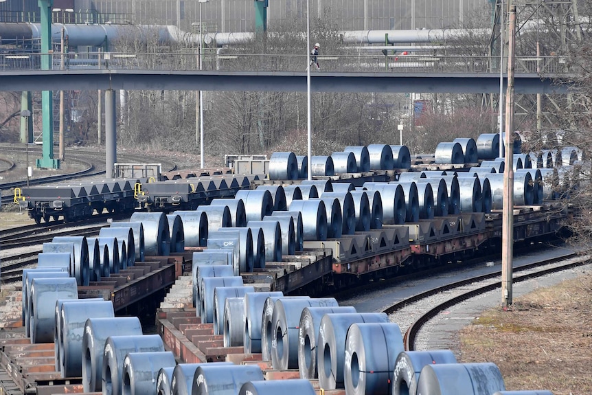 Steel coils sit on wagons at the thyssenkrupp steel factory