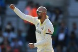 Nathan Lyon smiles and punches the air