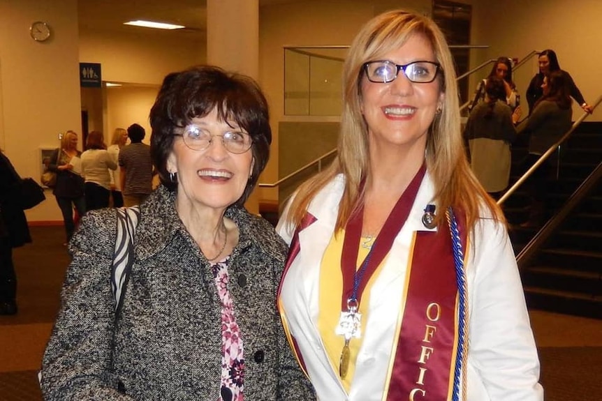 Two women smiling.