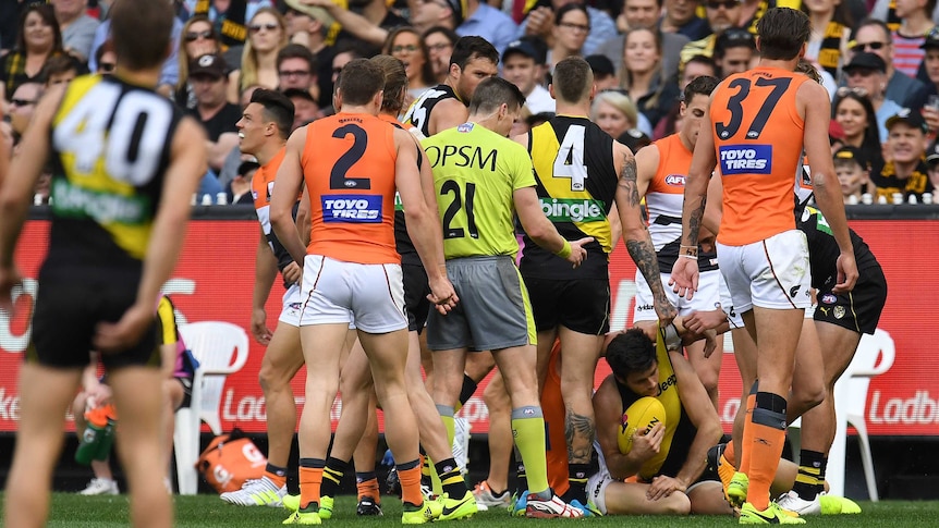 Trent Cotchin on the ground after collision with Dylan Shiel