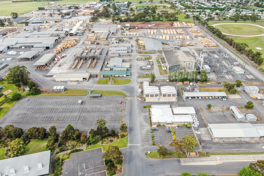 An aerial picture of a large worksite with large empty car parks.