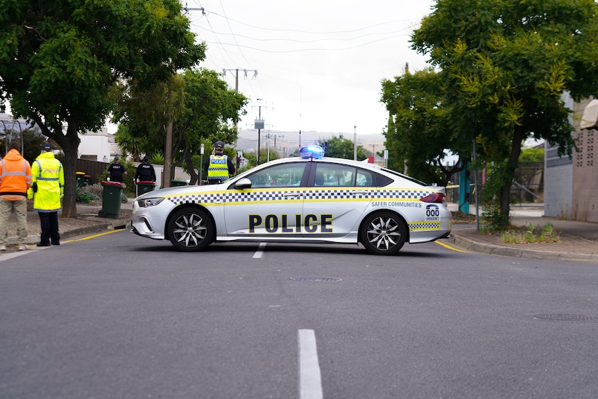 A police car blocks a road 