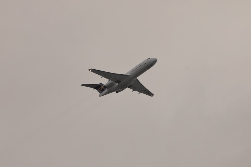 A plane flying over New Farm, in Brisbane