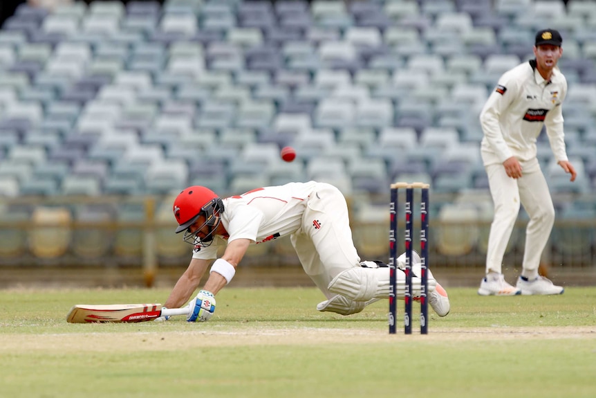 Callum Ferguson dives to the ground to avoid being run out for South Australia against Western Australia.
